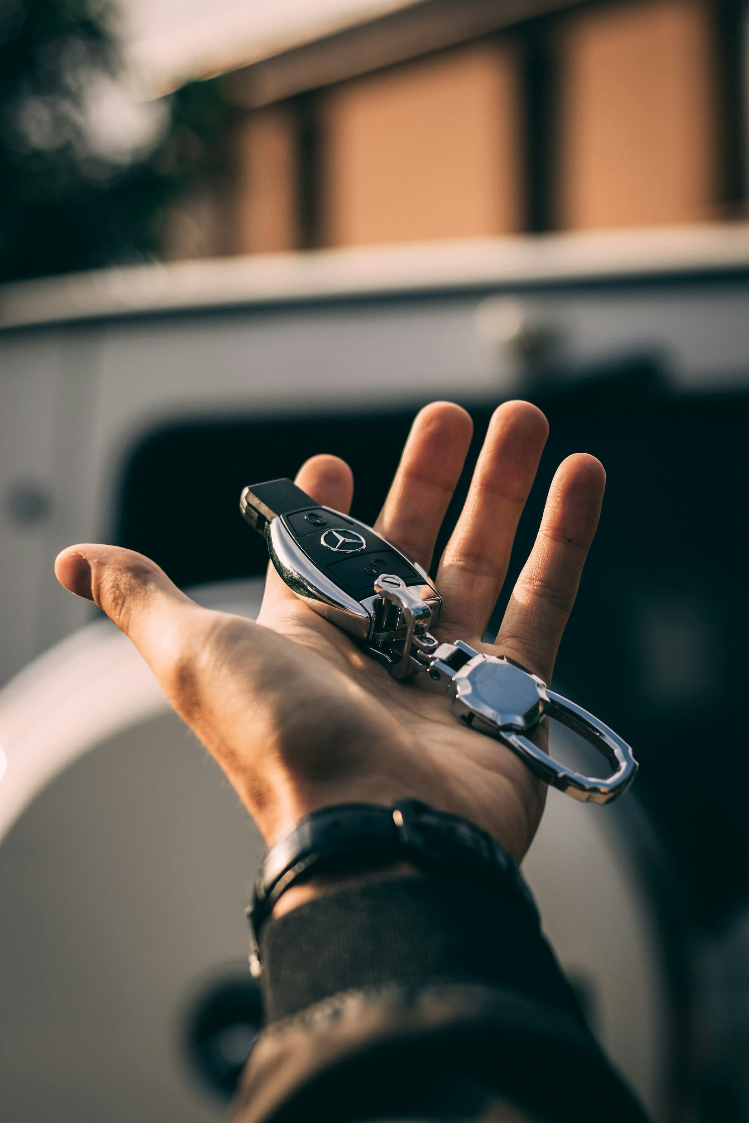 A car key resting in an open palm